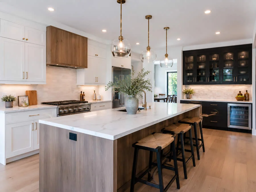 Remodeled open-concept kitchen with a large island and custom cabinetry in a suburban home